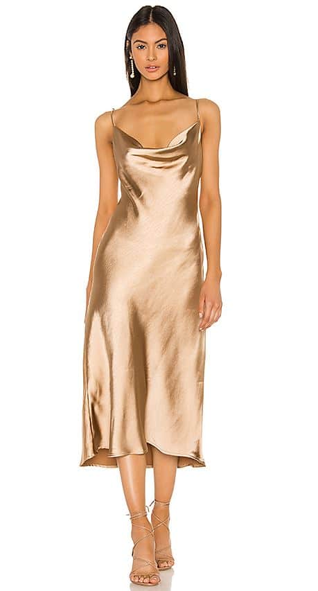 Model in gold slip dress