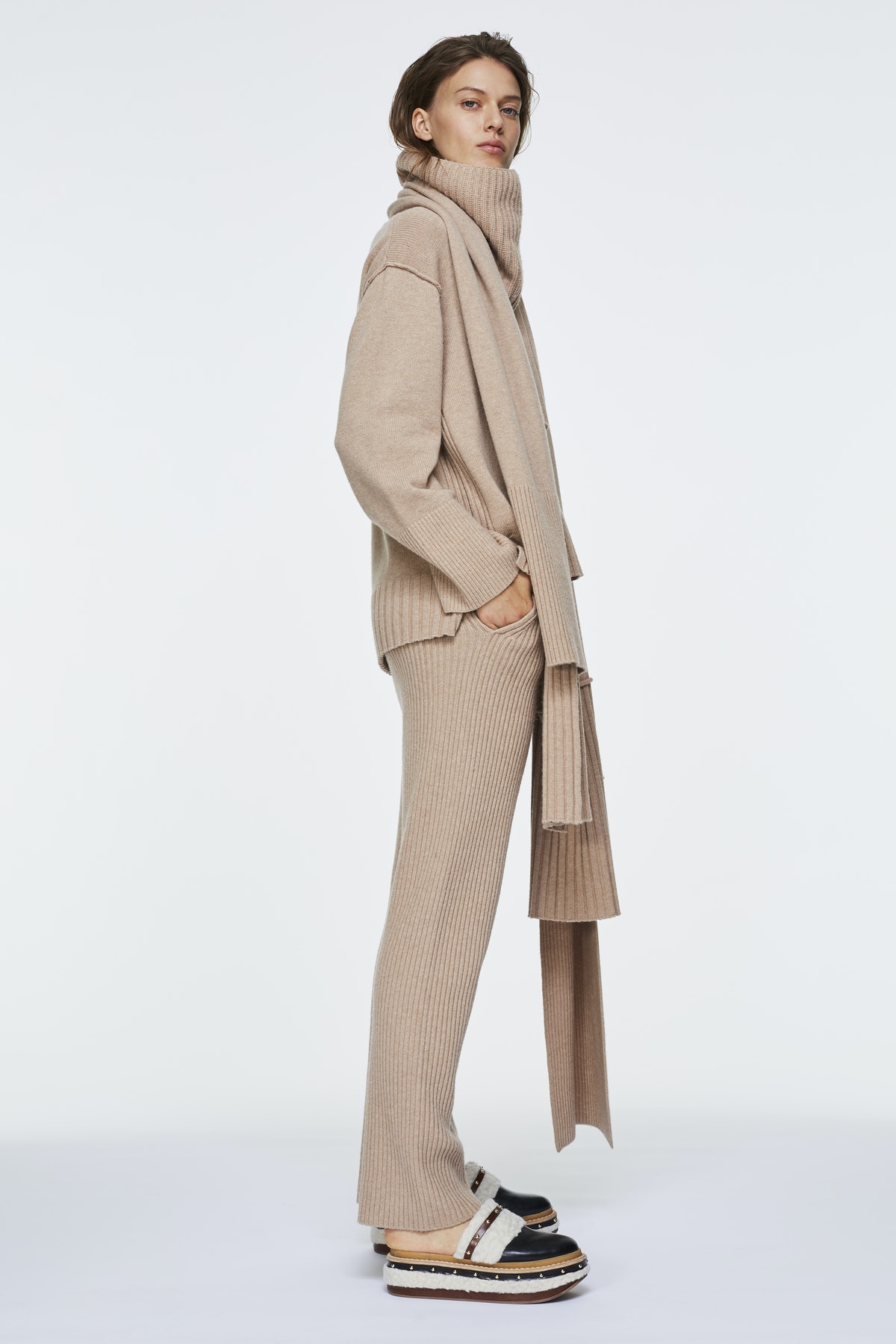 Girl in knitted beige suit