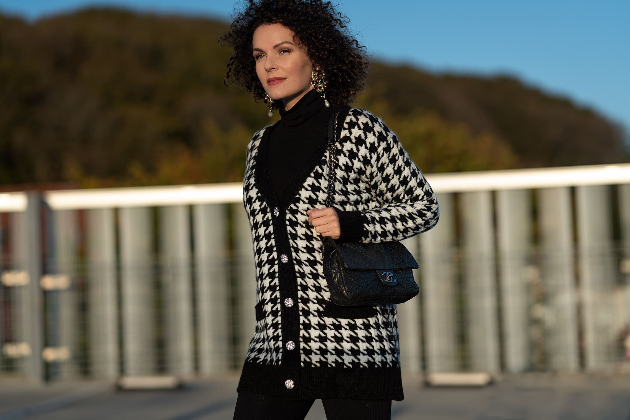 woman in black and white cardigan with chanel bag