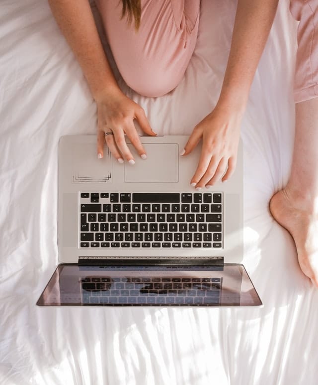 girl in bed with computer