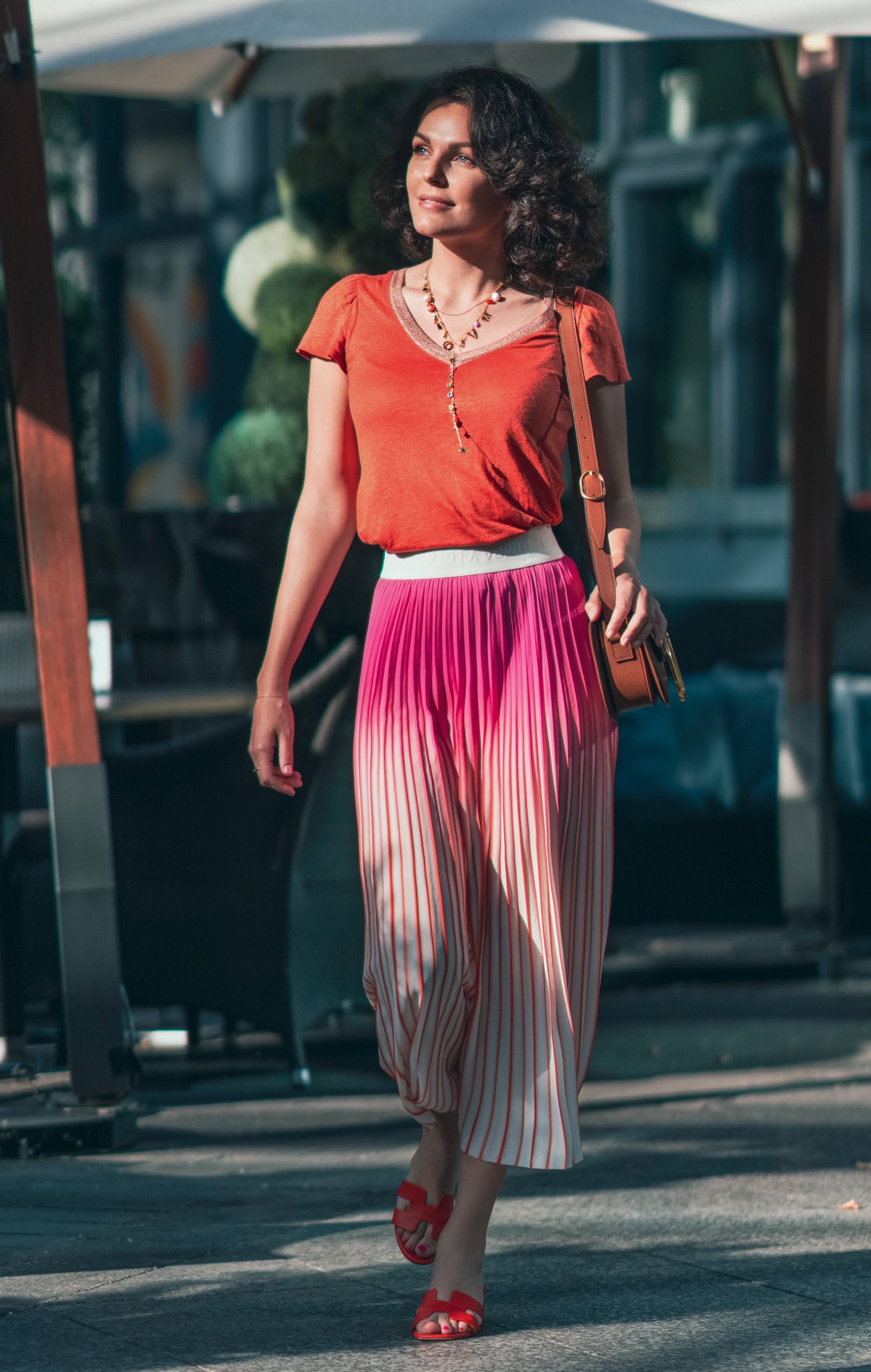 Girl in orange and pink walking